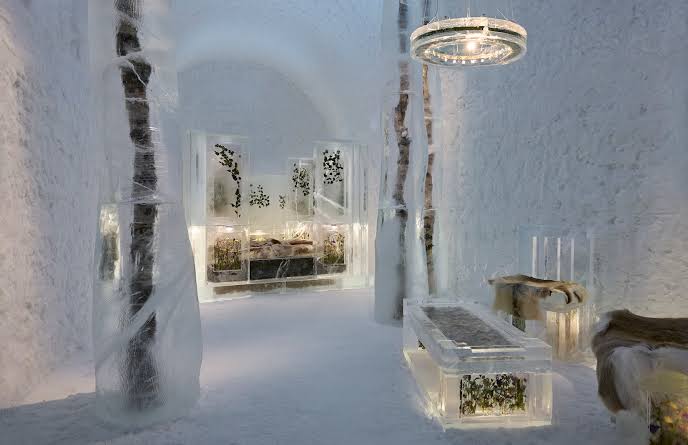 A corridor carved from snow and ice, lit from inside the walls.