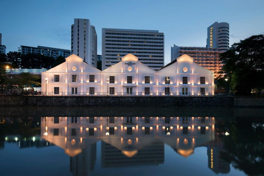 A three-gabled 1895 godown on the Singapore River, its roof trusses visible through tall windows.