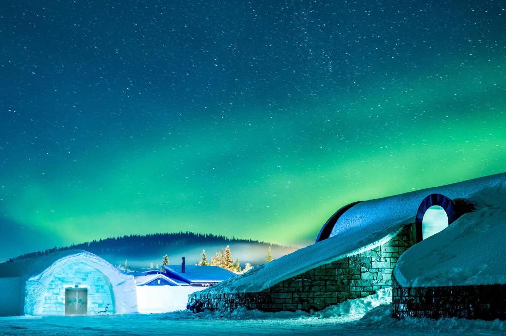 A room carved from river ice with a bed of ice blocks covered in reindeer hides.